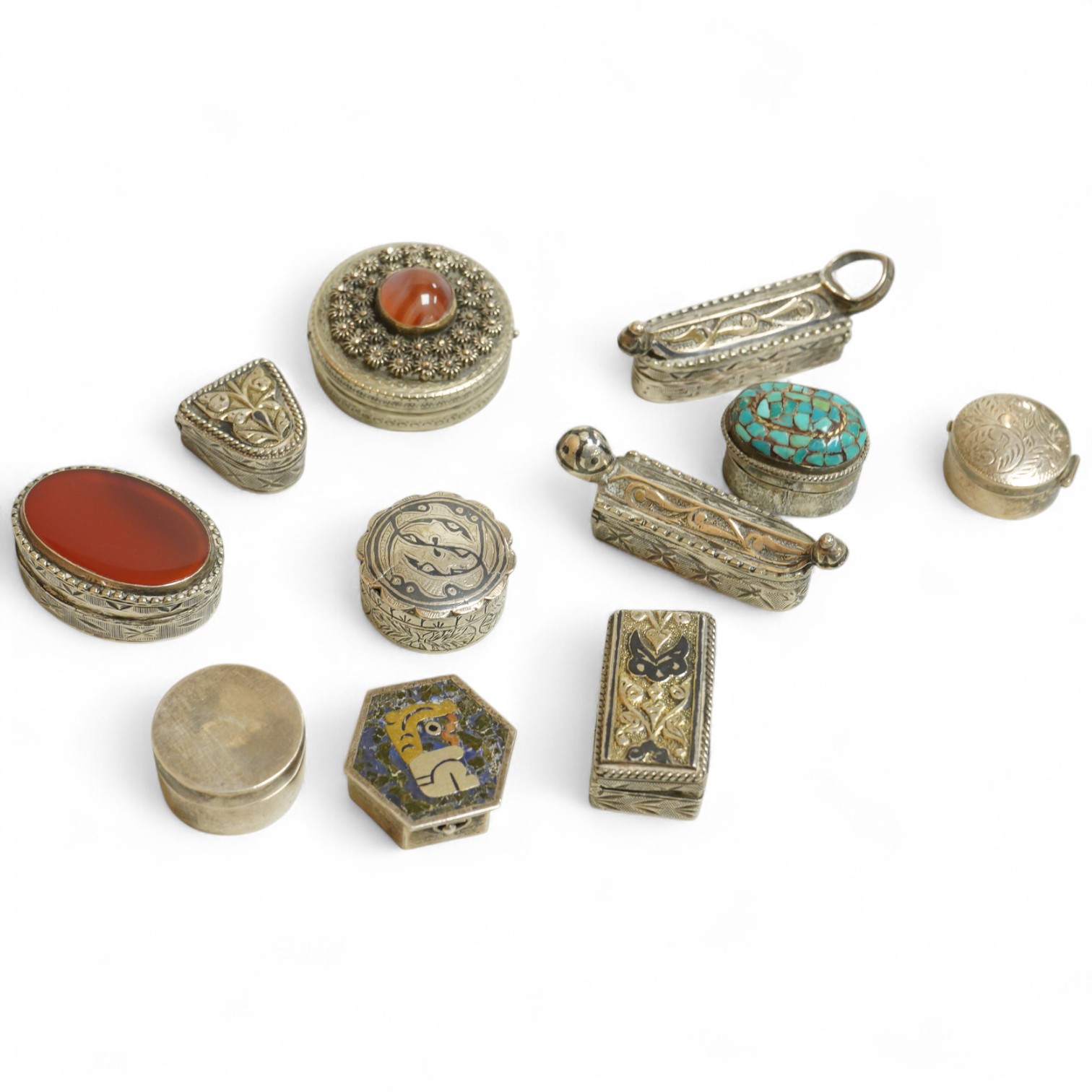 A collection of assorted pill boxes including one modern circular silver, a Mexican 925, six continental white metal, one inset with chalcedony and two with niello decoration and three other unmarked white metal pill box